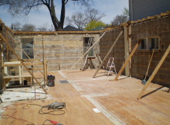 First floor exterior masonry walls braced in preparation for second and third storey addition above